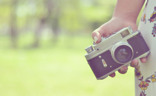 Close up of woman hand holding retro camera